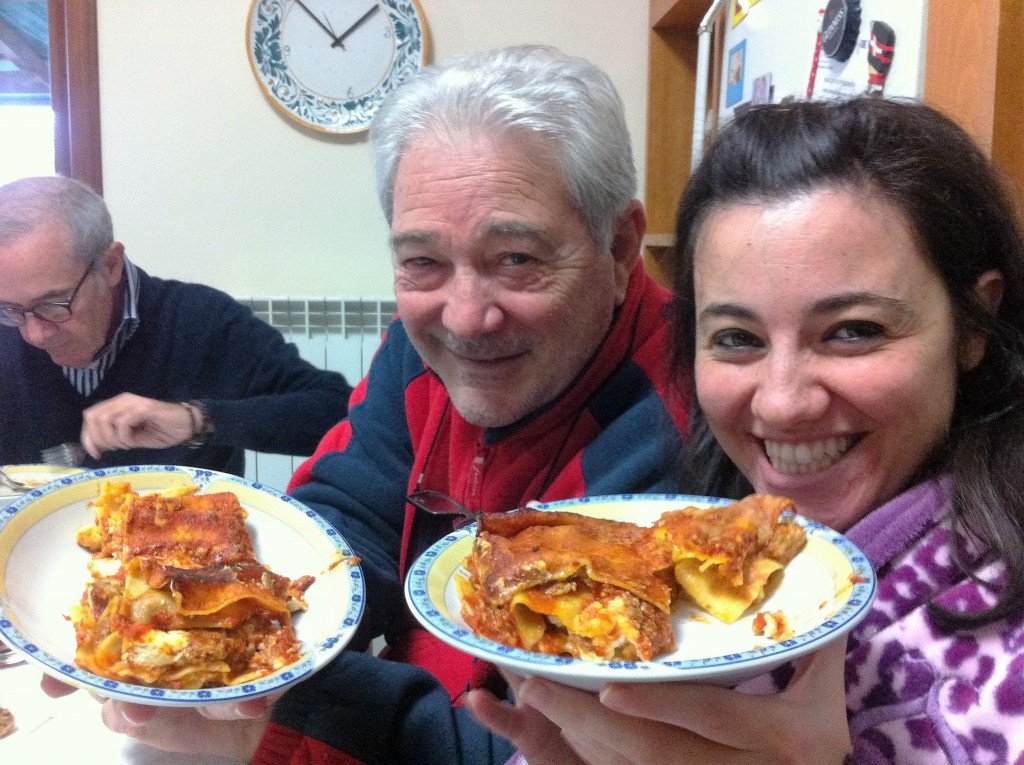 Smiling with uncle Eddie hiolding two plates with lasagne