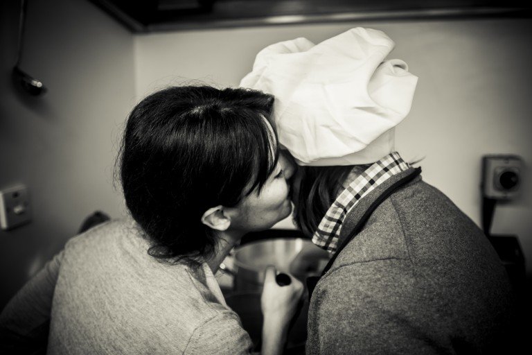 Mariacristina kissing george while preparing bechamel doe white lasagne