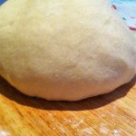 Potato gnocchi dough laid on a wooden surface