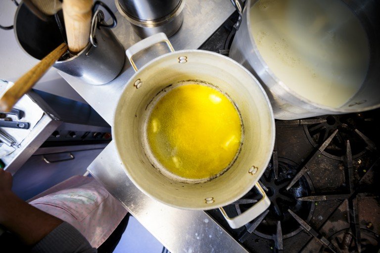 Big saucepan with butter melting to make bechamel for lasagne bianche